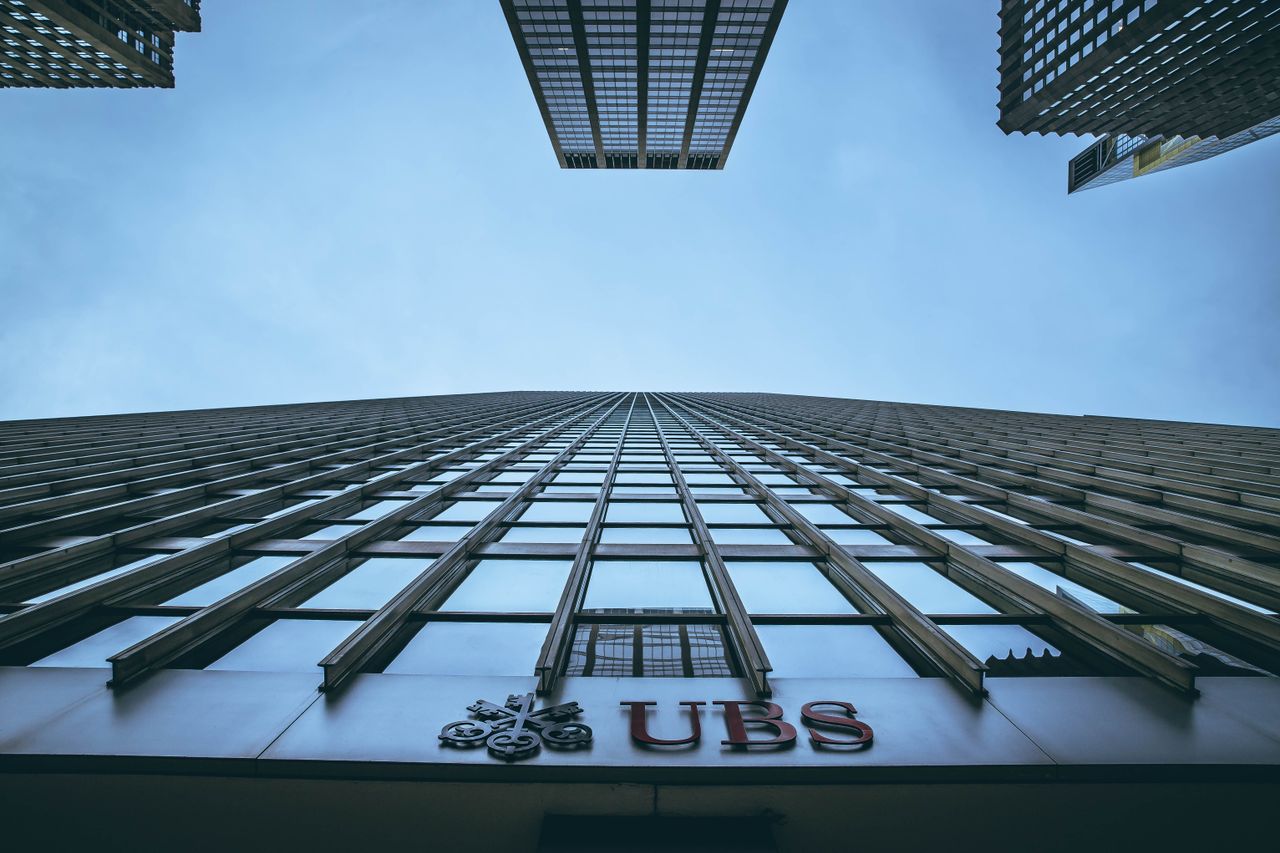 creative-02 Low angle view of New York skyscrapers with UBS logo, emphasizing height and urban architecture.